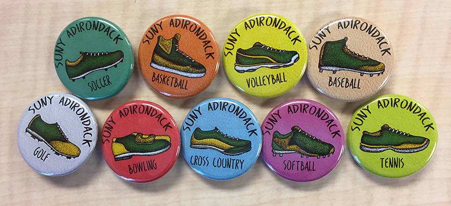 Buttons promote various SUNY Adirondack athletic programs.