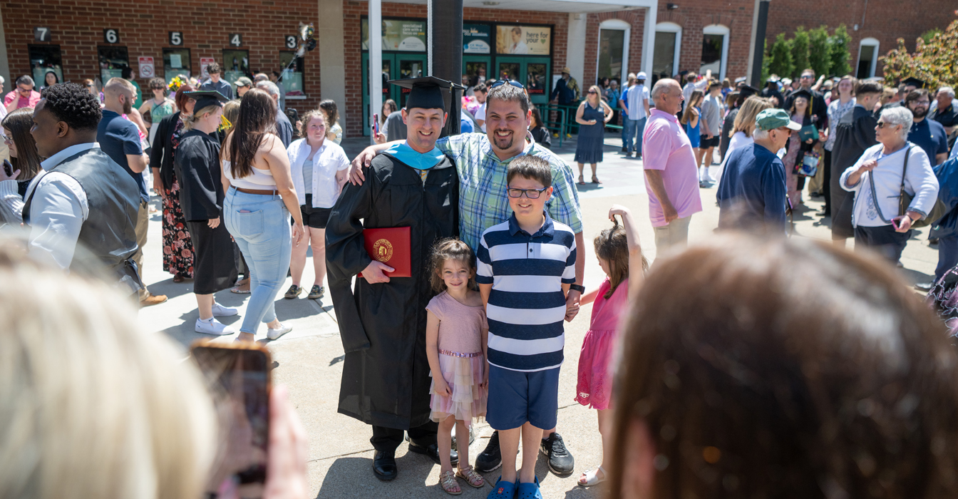 Plattsburgh graduate with his family at graduation