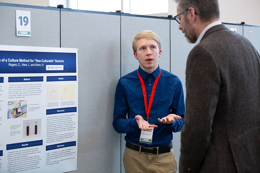 SUNY Adirondack student Cameron Rogers talks about a scientific project during the 2019 SUNY Undergraduate Research Conference.