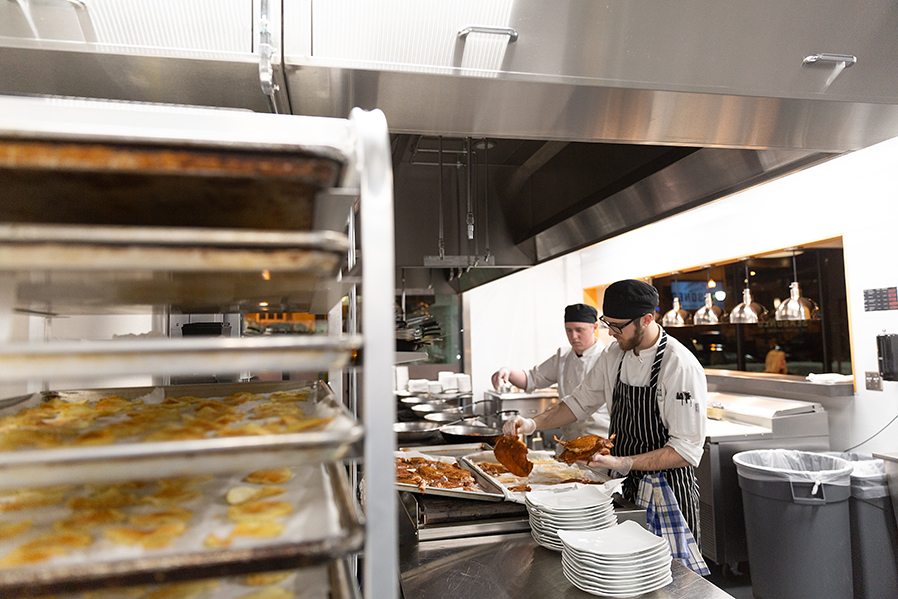 Culinary Arts students put the finishing touches on a dish during a recent dinner service at Seasoned.