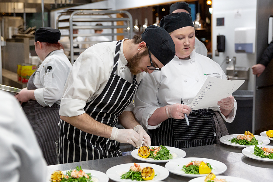Students in the SUNY Adirondack Culinary Arts program put the finishing touches on a dish during a recent dinner at Seasoned in downtown Glens Falls.