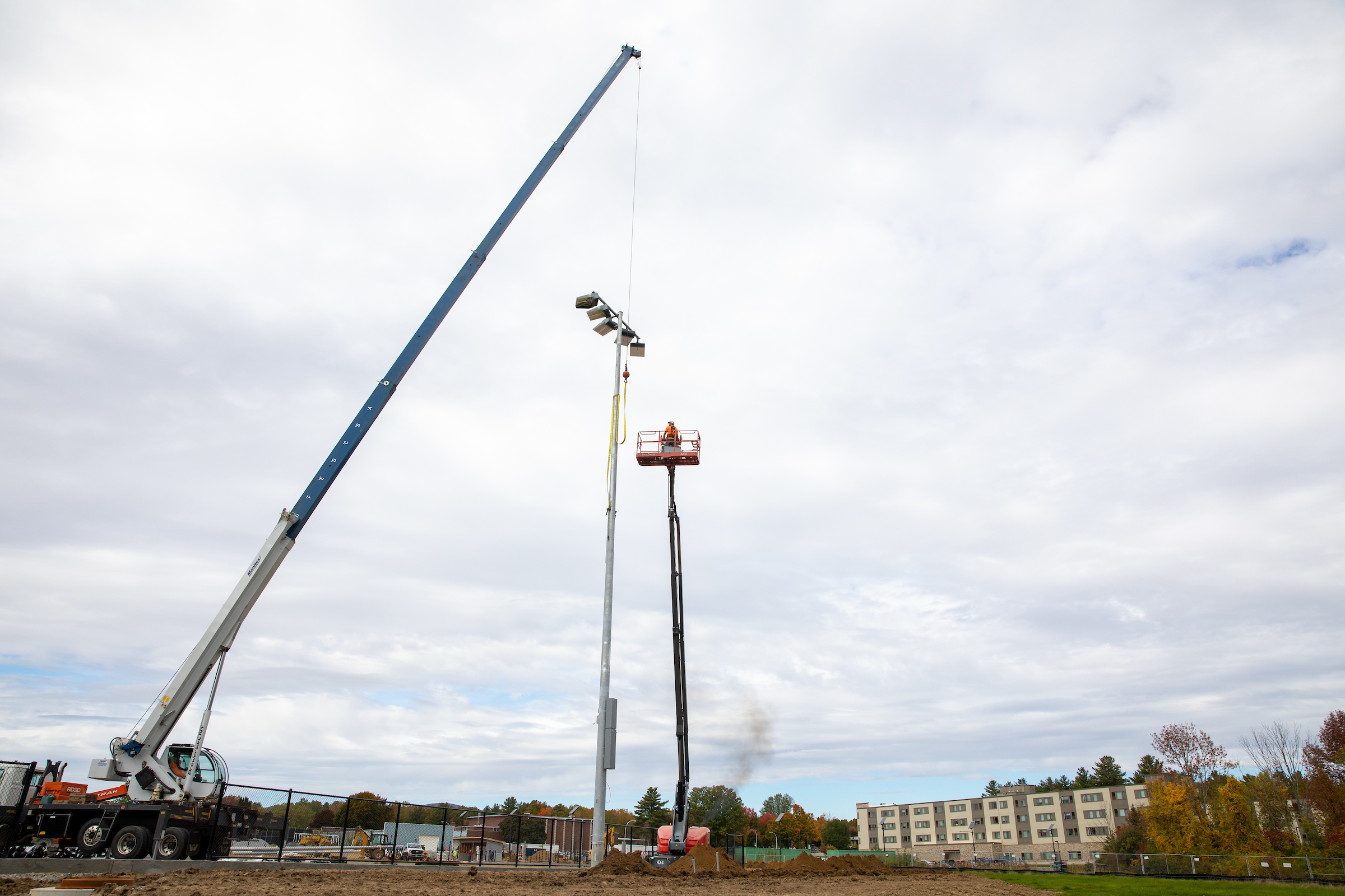 Lights are installed on the turf field project at SUNY Adirondack.