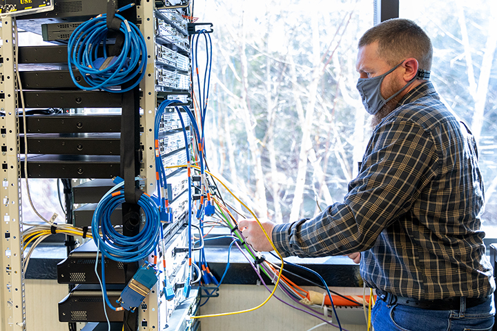 image of male cybersecurity student working in the networking lab