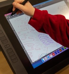 close up of a media arts student using a tablet to illustrate