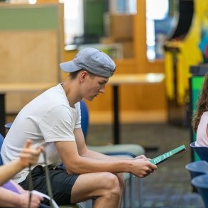 A young man looks over brochures at Accepted Student Day