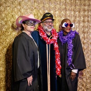 English faculty members pose in silly dress-up clothes at Commencement 2025