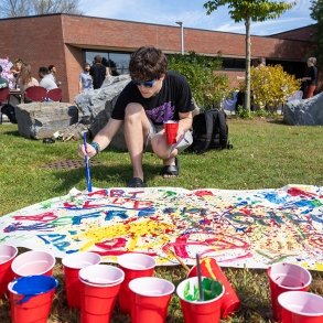 A student participates in a painting activity during Fresh Check Day 2024
