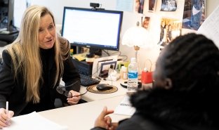 Professor of Business Kelli Hatin advises a student in her office