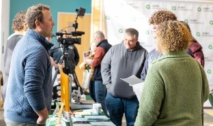 Nick Ameden, Media Arts professor, left, speaks with prospective students and their families at an Open House event in Northwest Bay Conference Center.