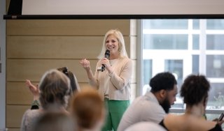President Kristine D. Duffy, Ed.D., speaks to a group of students on campus.