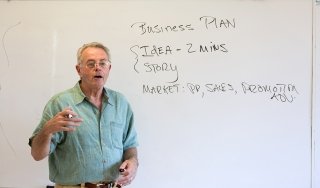Business Professor Chandler Atkins delivers a lesson in a classroom on campus