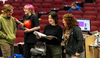 Mary Pilot, second from right, reviews notes for an upcoming production of "The Addams Family"