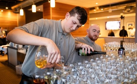 Students pour wine as part of Vintners Night at Seasoned.