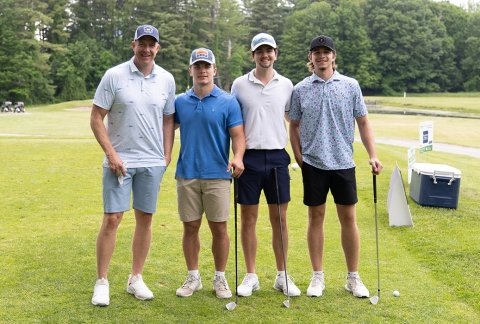 A foursome poses for a quick photo between holes at the Beeman Golf Tournament