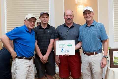 A team of golfers pose for a photo during the 2019 tournament