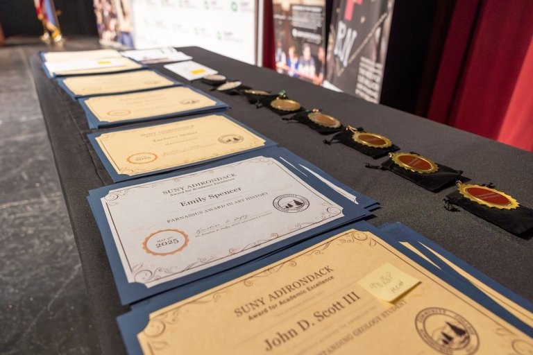 Awards line the table at the annual Academic Achievement Awards ceremony