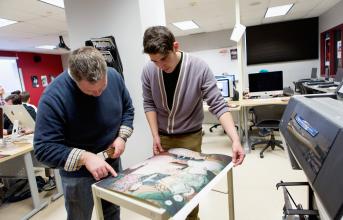 Media Arts professor Nick Paigo works with a student in the studio