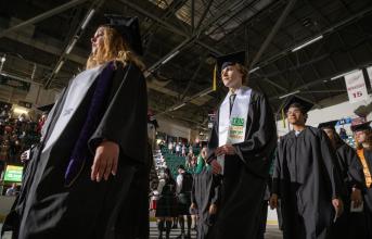 Graduates walk down the aisle during Commencement 2023.